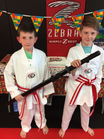 Iron Fist students posing with sword